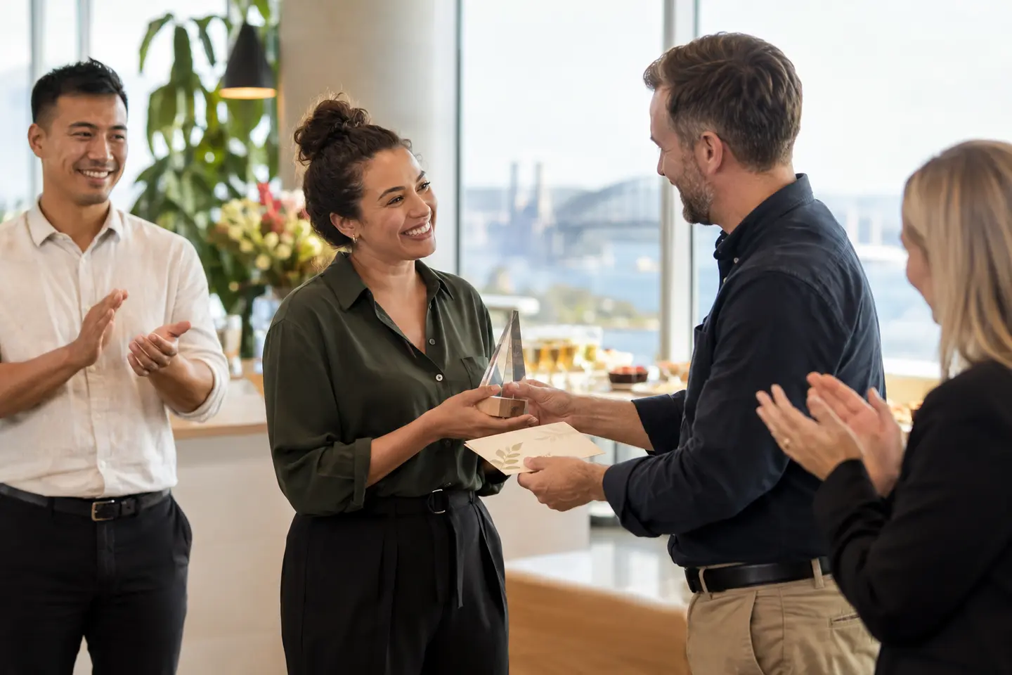 An employee being recognised by colleagues in a corporate workplace